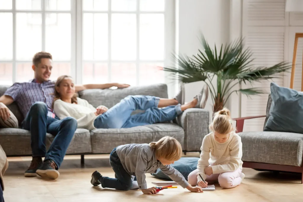 Family smiling in front of their hurricane impact windows