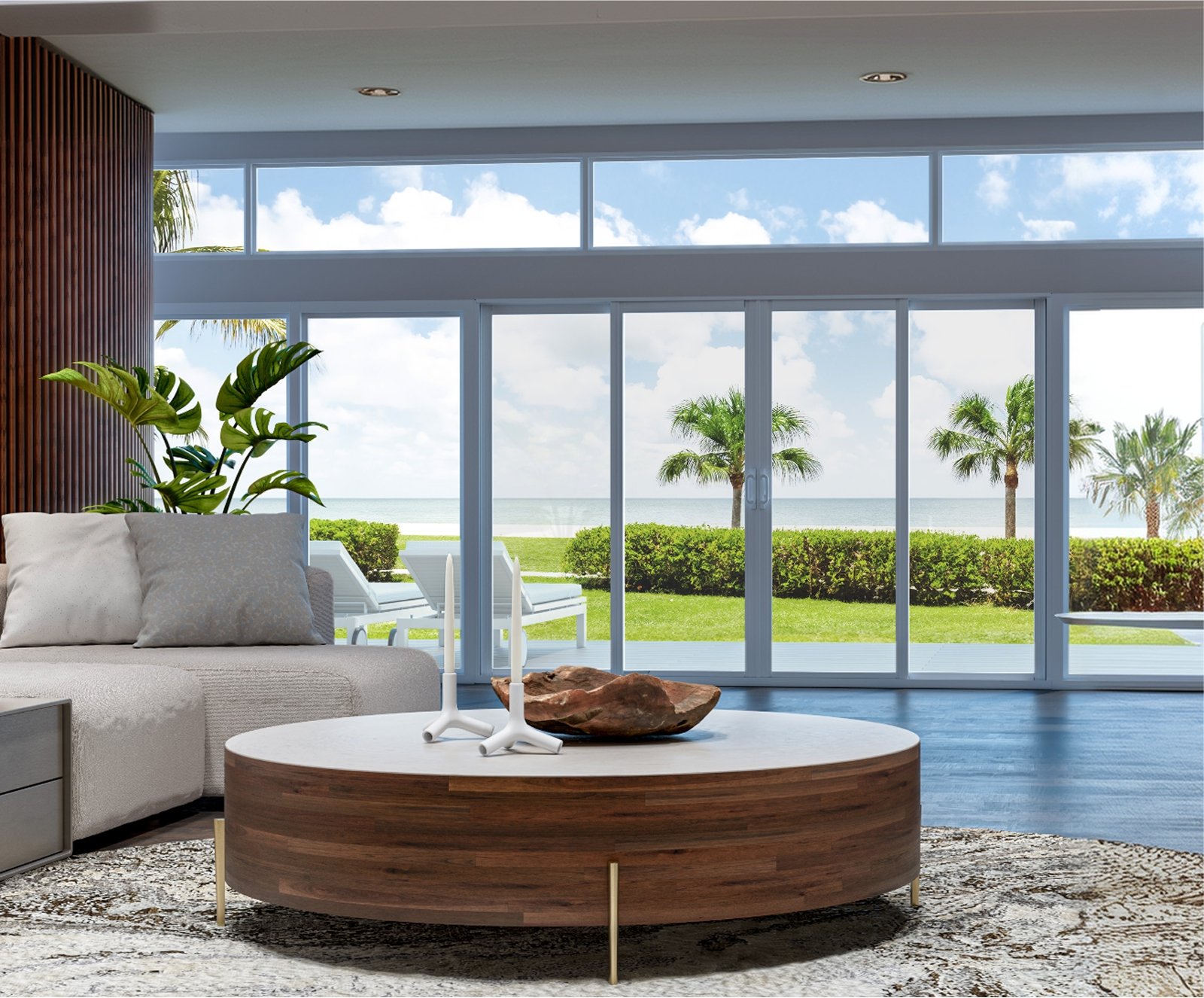 Living room with white-framed windows and sliding glass doors overlooking palms and the ocean