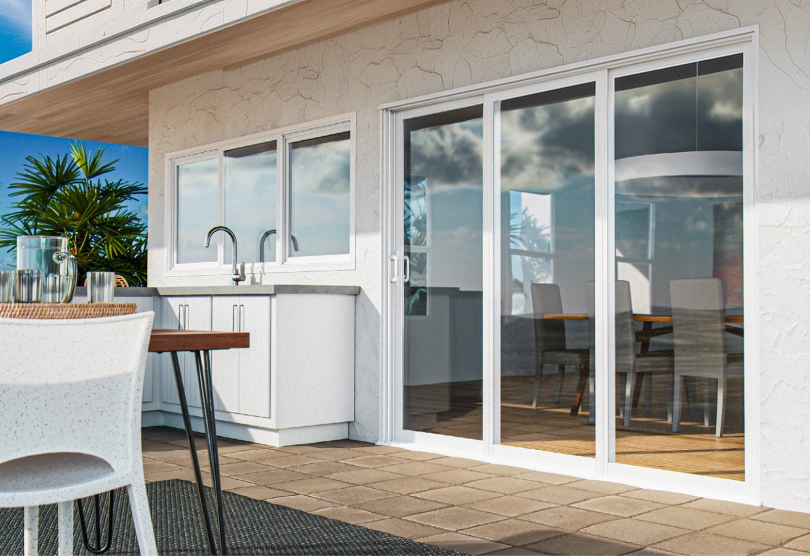 White-framed sliding glass doors and a window beside a covered patio kitchen